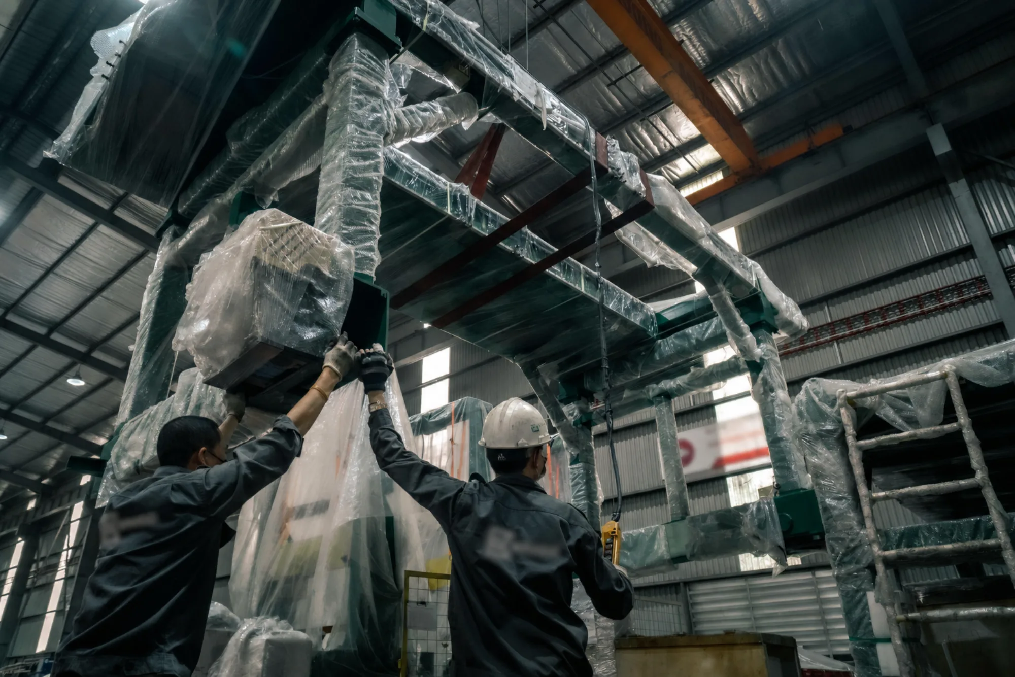 Industrial specialists handling large commercial machinery